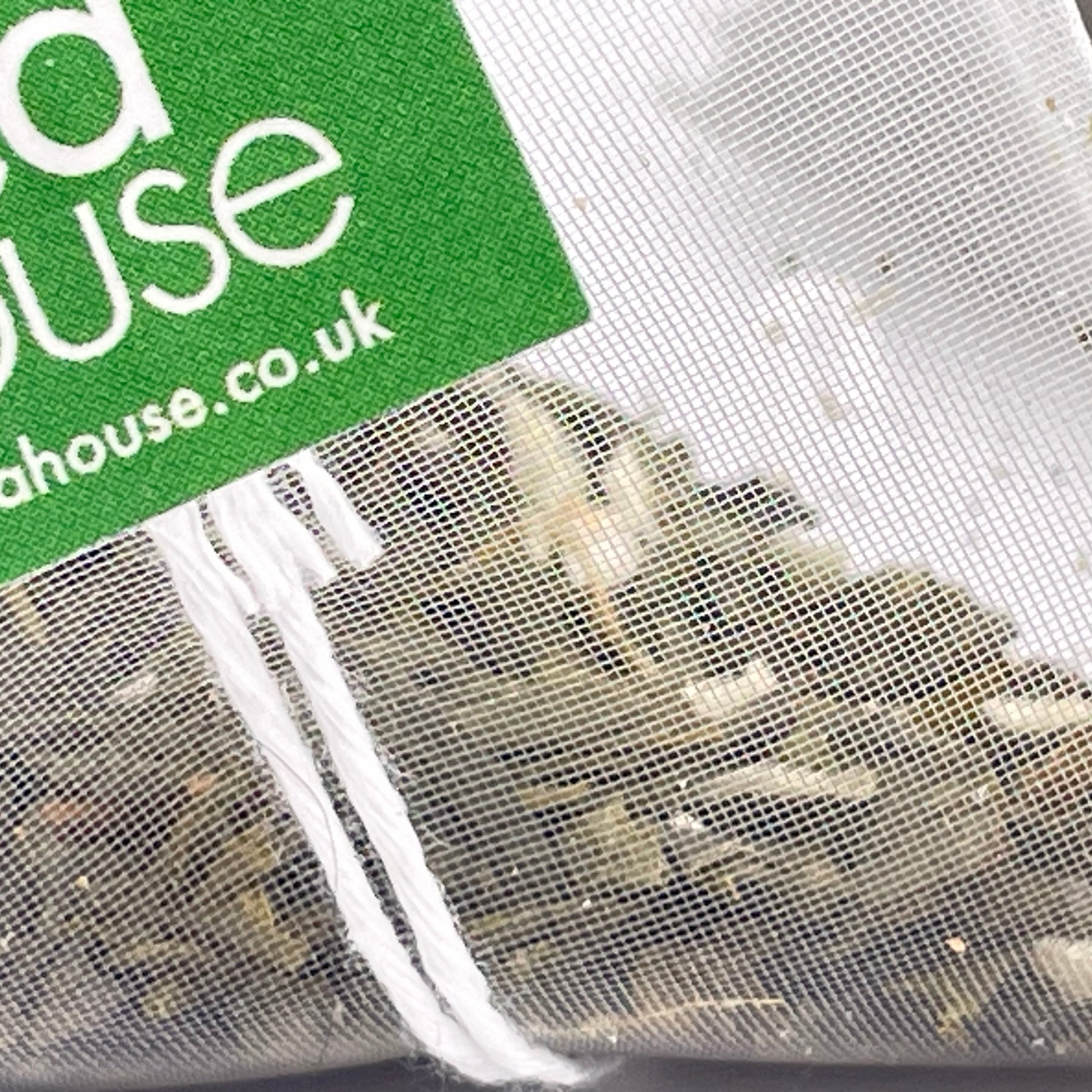 Tea bags with a green label displaying 'theteahouse.co.uk' on a white background.