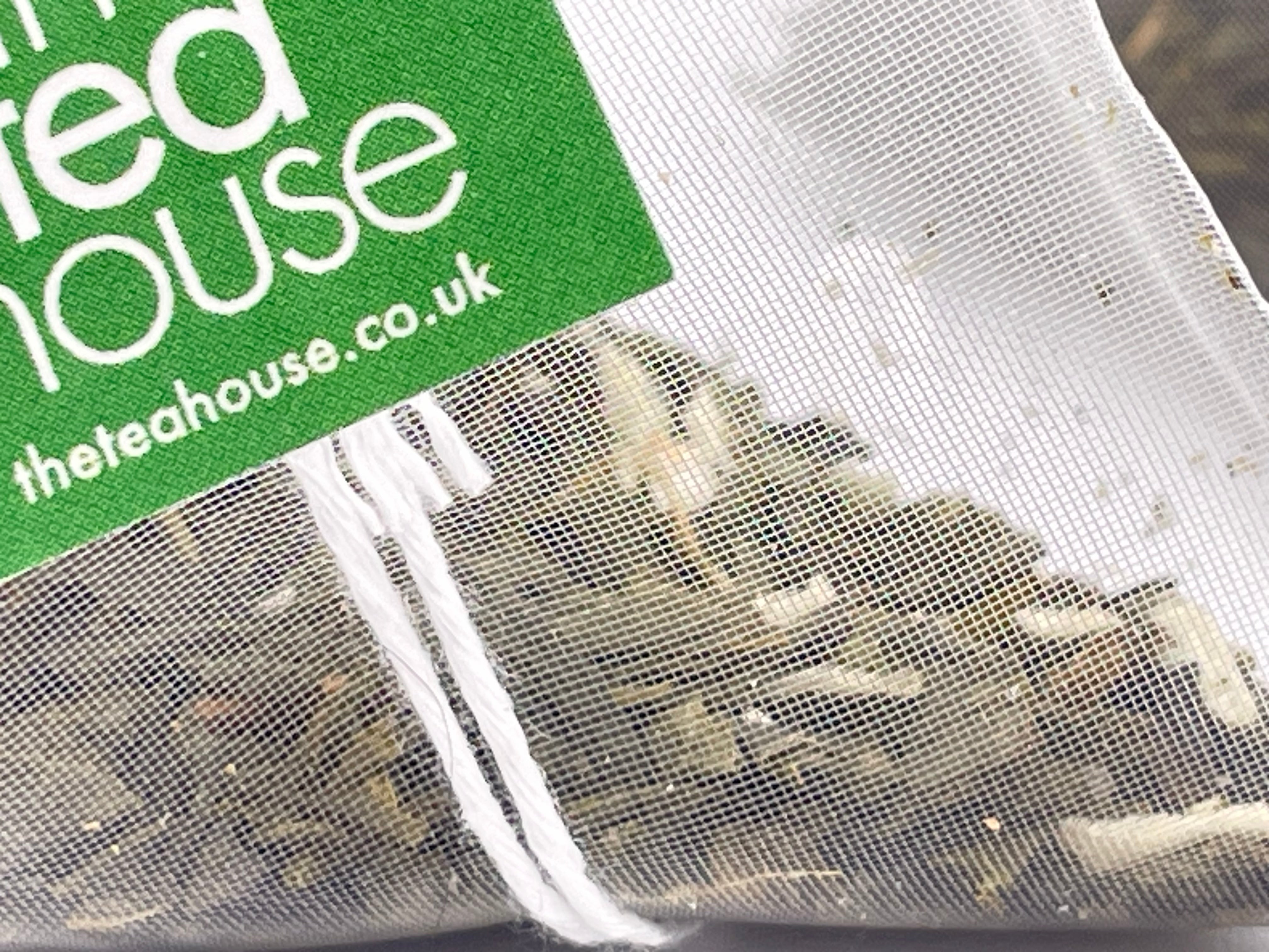 Tea bags with a green label displaying 'theteahouse.co.uk' on a white background.