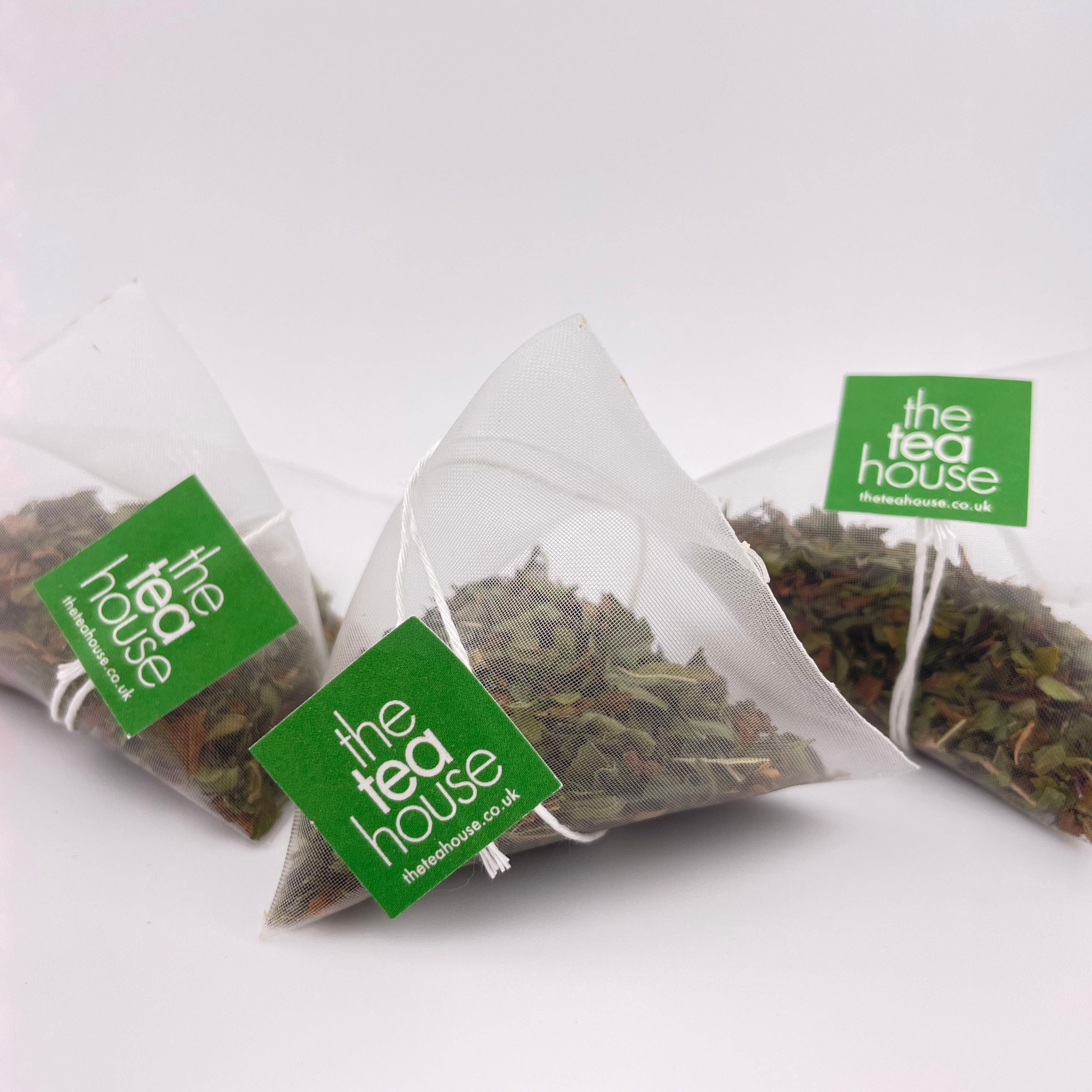 loose leaf teas in teabags on white background