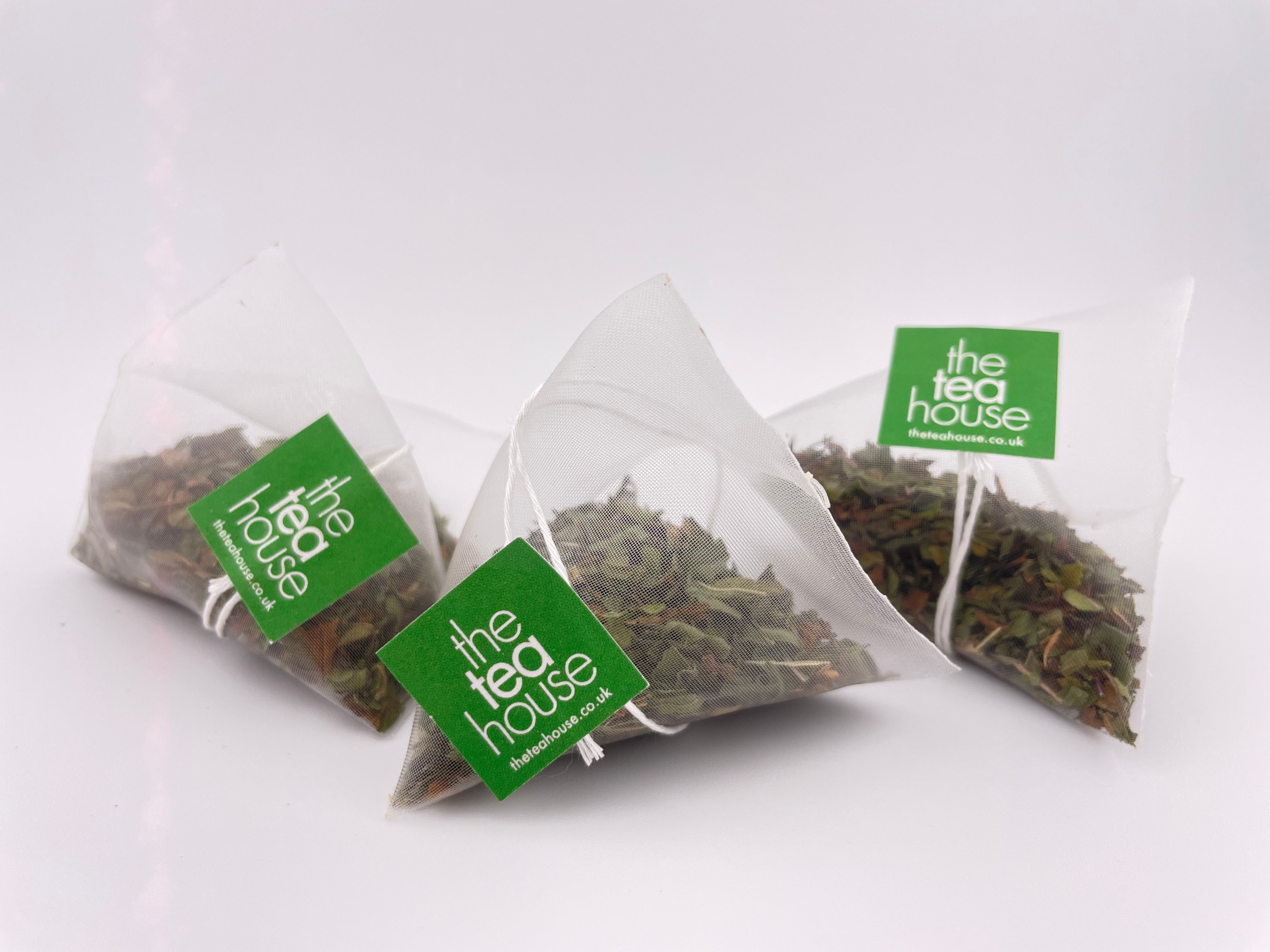 loose leaf teas in teabags on white background