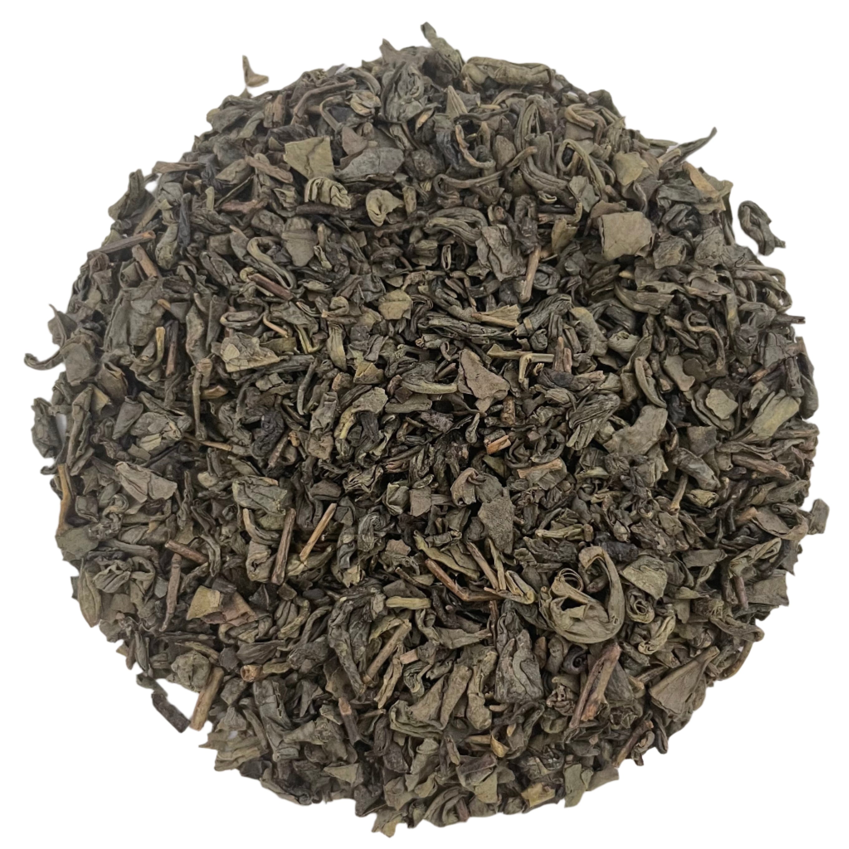 Dry green tea leaves on a white background