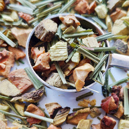 Liquorice Delight fruit and herbs in a spoon on a white background