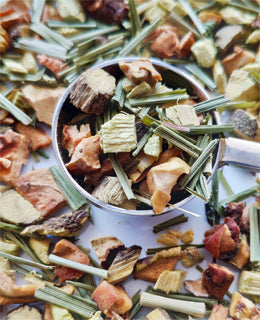 Liquorice Delight fruit and herbs in a spoon on a white background