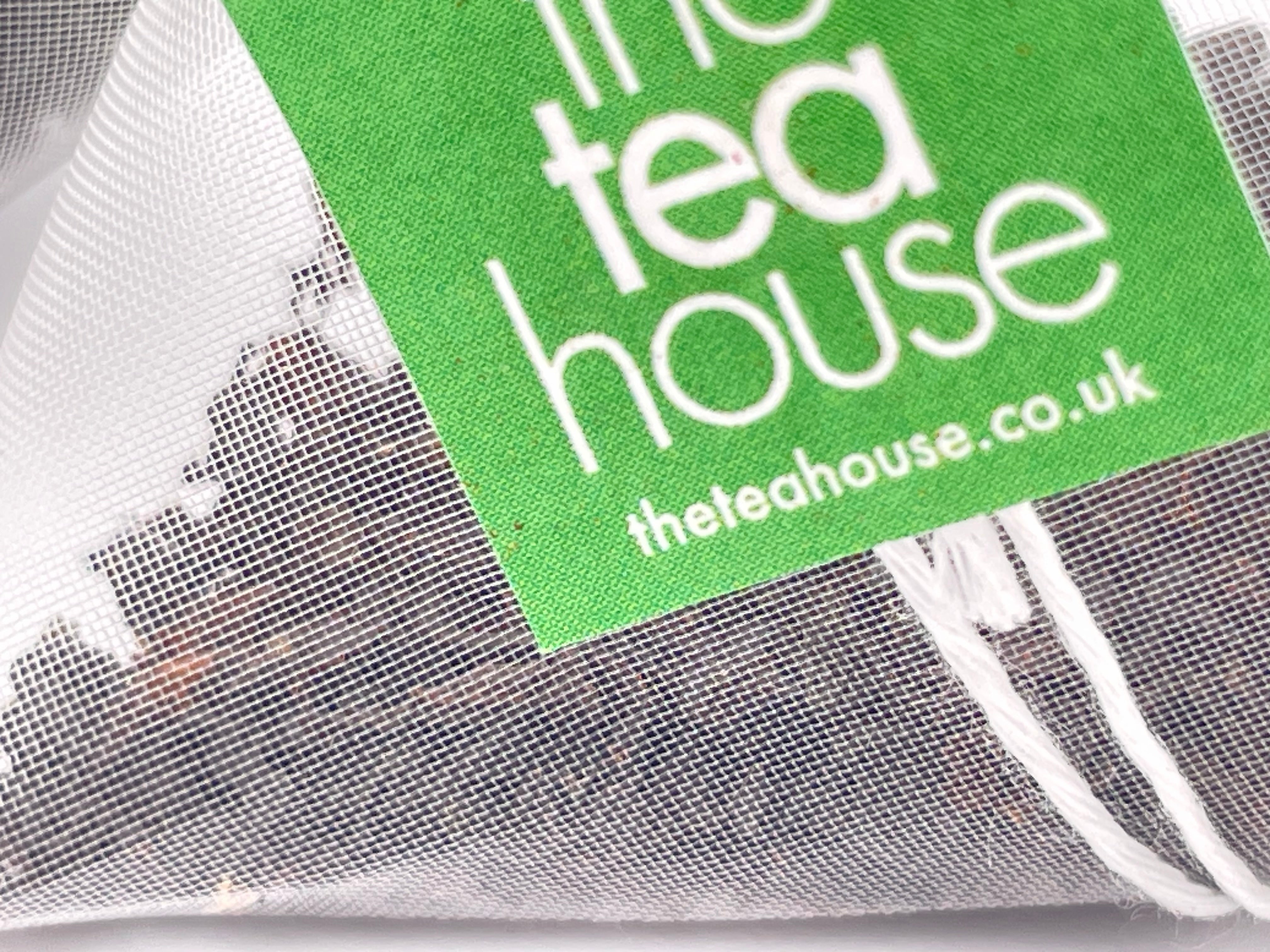 Teabag with loose leaf tea and tag "theteahouse"