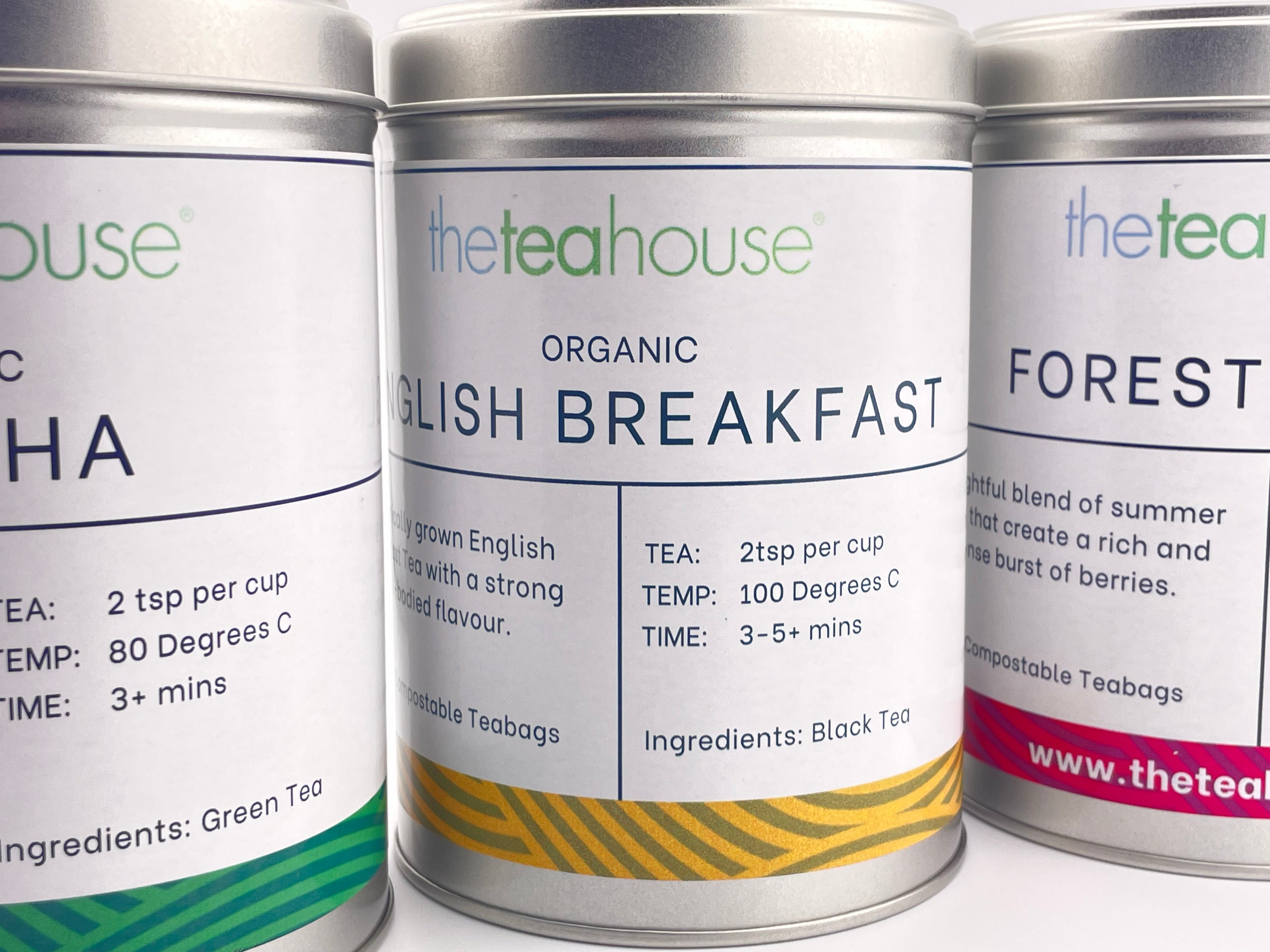 silver tins with tea labels on white background