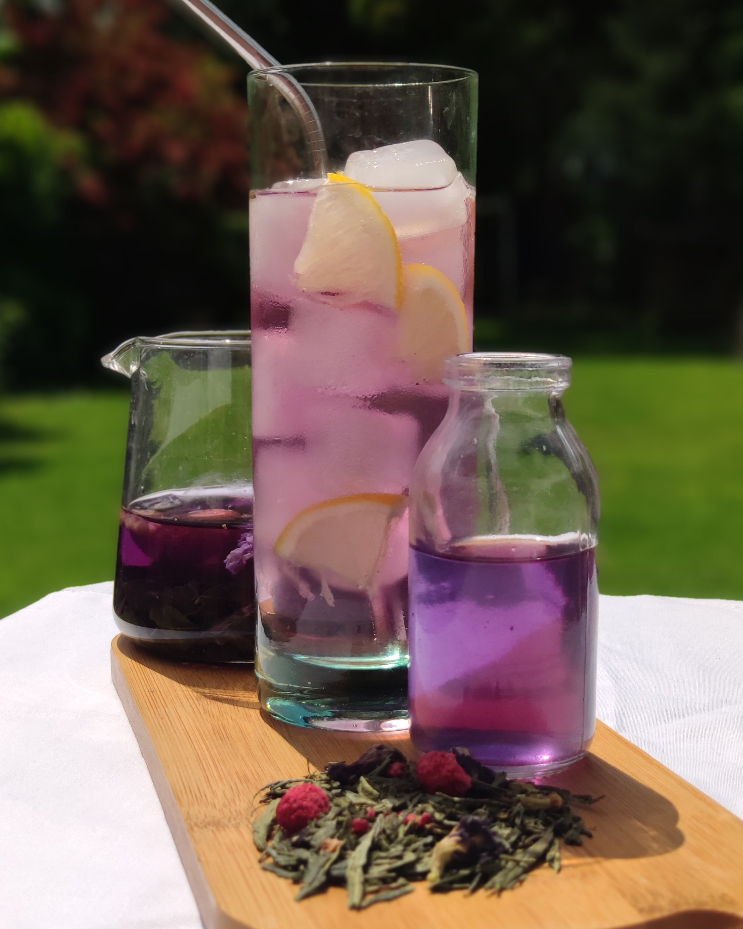 tall clear glass of purple liquid tea