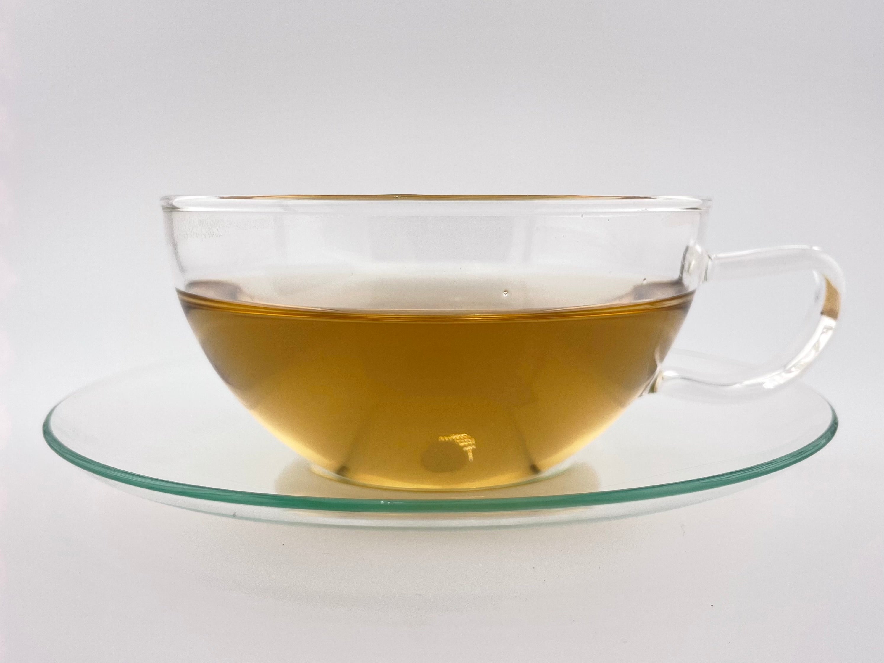 yellow liquor in a clear tea cup